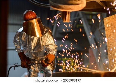 A Steelworker When Casting Draining Metal From A Cupola Furnace. Metallurgy.