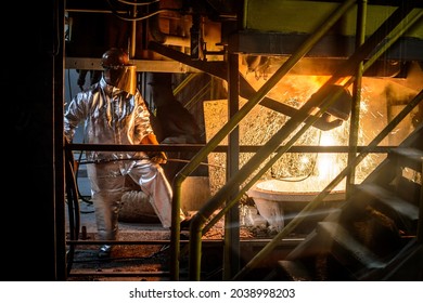 A Steelworker When Casting Draining Metal From A Cupola Furnace. Metallurgy.