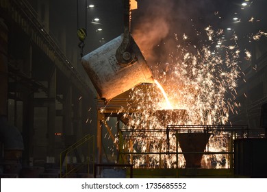 steelworker at work pouring metal in the workshop - Shutterstock ID 1735685552