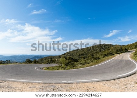 A steep bend in the road in the mountains of Corfu, Greece