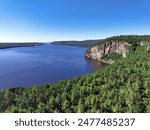 Steep cliffs and thick forest on the north shore of the Ottawa River in Quebec