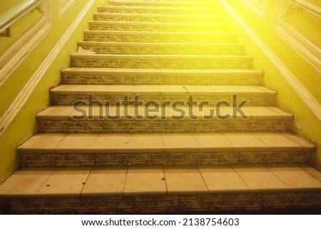 Steep concrete stairs in St. Petersburg house with beautiful sunlight at above.
