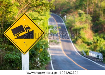 Steep grade traffic sign on the roadside, uphill asphalt road in countryside