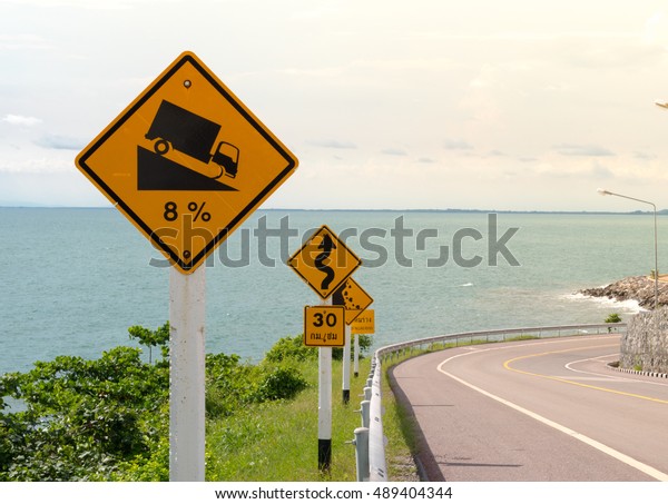 Steep Hill Descent Signs with Scenery along The
Beach Road