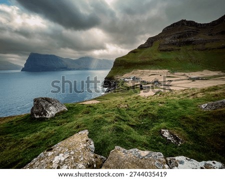 Steep Oceanfront Precipice Under Brooding Storm Clouds With Sparse Grass And Distant Sea Stacks
