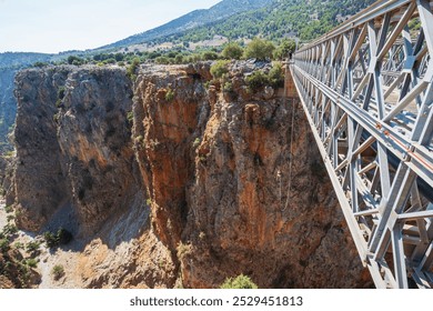 Steep rocky gorge with bridge, bungee jumping, in the sun, Aradena bridge, Greece, Crete island, wide angle lens - Powered by Shutterstock