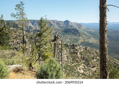 The Steep, Rocky Terrain Of Arizona's Mogollon Rim Above A Forested Valley