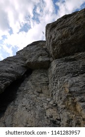 steep tall cliffs under the cloudy blue sky