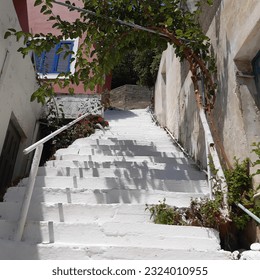 Steep whitewashed staircase in a side street in Therma village, Ikaria island, Greek islands, Greece, Europe, Greek island in the Aegean Sea, North Aegean  - Powered by Shutterstock