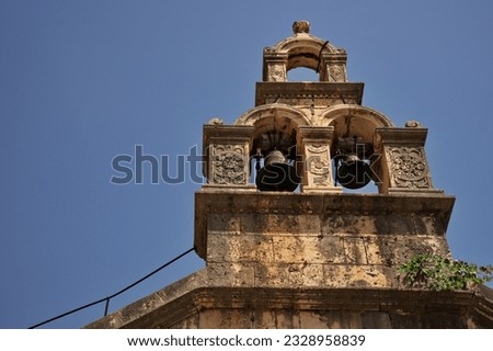 Steeple of medieval stone church against sky