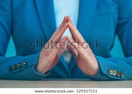 Steepled fingers of business woman as hand gesture sign of confidence, self-esteem, power and domination.