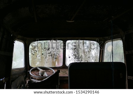 The steering wheel and dashboard of an Old van.