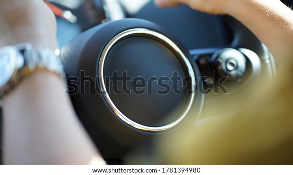 The steering wheel and the driver wear a watch\
while driving.