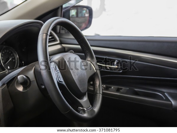 Steering wheel and\
interior view of car.