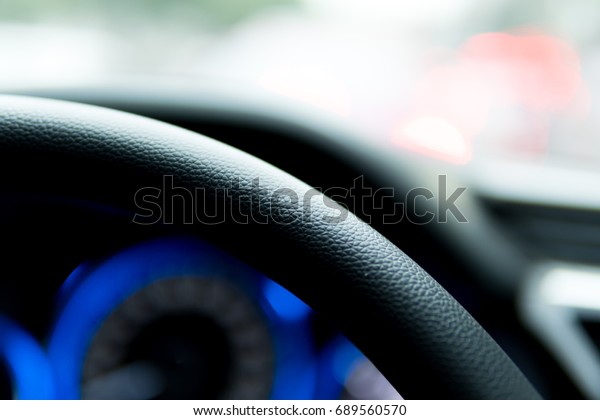 Steering\
wheel (interior view of car), selective\
focus.