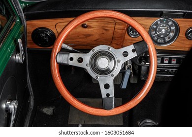 steering wheel of an old mini cooper showing also the dashbard with speedometer and air vents