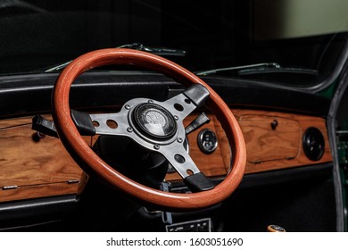 steering wheel of an old mini cooper showing also the dashbard with speedometer and air vents