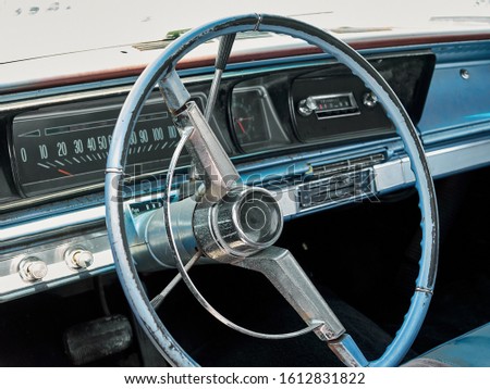 Steering wheel and panel with dashboard in interior of old retro american car