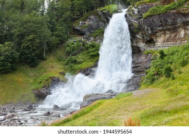 Steinsdalfossen Huge Waterfall. Norway. Summer. Waterfall Among The Forest. Scandinavian Landscape And Rocks. Water Energy.