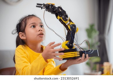 STEM education concept. Asian students learn at home by coding robot arms in STEM, mathematics engineering science technology computer code in robotics for kids' concepts. - Powered by Shutterstock