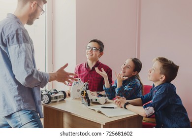 Stem Education. Kids Creating Robots With Teacher. Scientist Explain New Material To Group. Early Development, Diy, Innovation, Modern Technology Concept