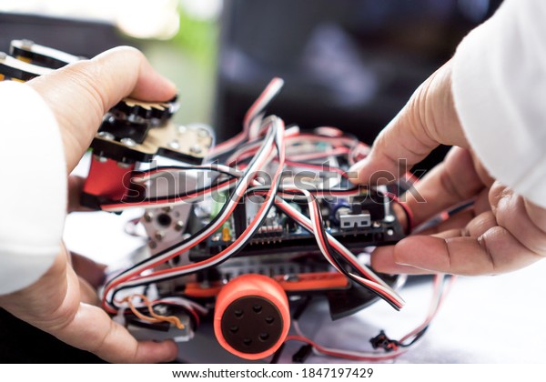 STEM Education for Learning, Hands student on\
Electronic board by robotics electronics in laboratory in school.\
Concept of Mathematics, engineering, science, technology for\
innovation in classroom