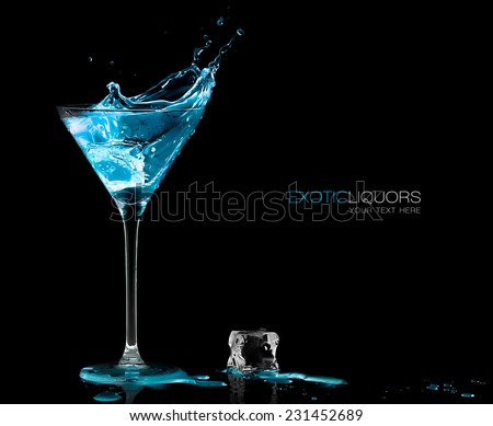 Stemmed cocktail glass with blue alcoholic drink splashing out, close-up isolated on black. Template design with sample text