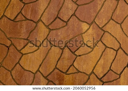 Stencilled brown artificial stone floor pavement texture and background