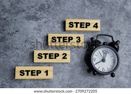 step 1 to step 4 in a row stacked wooden cubes on the table. step-by-step planning concept