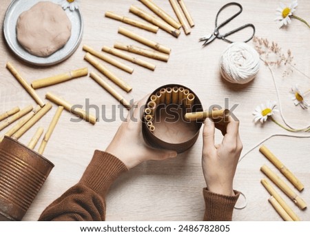 Step 4. Stack the pieces of bamboo inside the can. Create a DIY bug hotel for garden. Kids craft and helping wild animals concept. Top view.