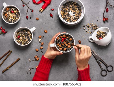 Step 5. Child Inserting A Branch Into The Cup With Birdseeds And Coconut. Easy Homemade Bird Feeder Kids Craft And Helping Wild Animals Concept. Top View.