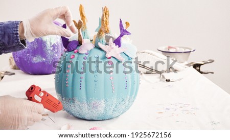 Step by step. Decorating art pumpkins with rhynestones, mermaid tails, and seashells in mermaid theme for Halloween.