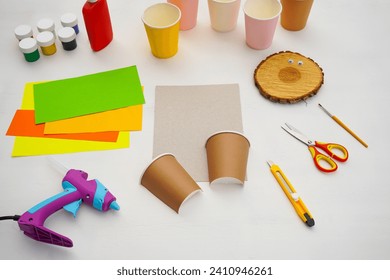 Step by step diy process. Point 2 Cut the paper cup in half. Kids craft giraffe from a paper coffee cup, zero waste concept.