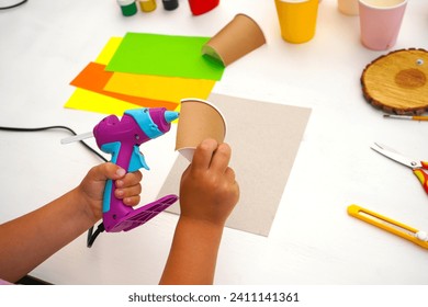 Step by step diy process. Point 3 Glue the halves of the glass onto the cardboard. Kids craft giraffe from a paper coffee cup, zero waste concept.