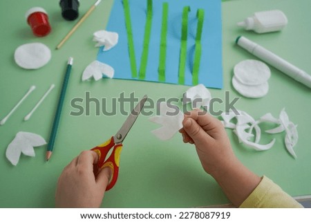 Step by step diy process. Zero waste concept. Creativity, crafting. Spring snowdrops made of cotton pads. Step 4 - cut out white snowdrop flowers from cotton pads