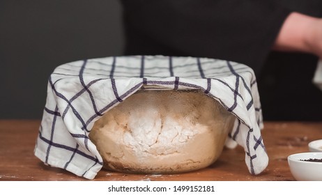 Step By Step. Dough Set To Rise In A Large Glass Mixing Bowl And Covered With Kitchen Towel.