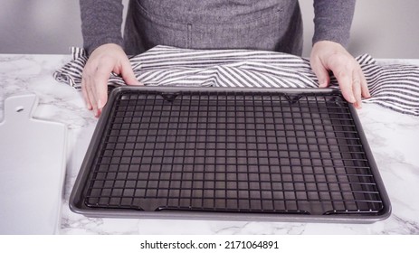 Step By Step. Empty Cookie Tray With Drying Rack On A Marble Kitchen Surface.