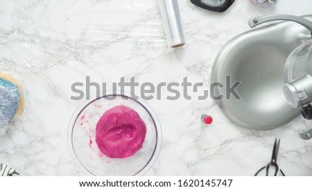 Step by step. Flat lay. Mixing food coloring into the cookie dough to bake red, white, and blue pinwheel sugar cookies.