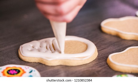 Step By Step. Flooding A Sugar Skull Cookie With White Royal Icing.