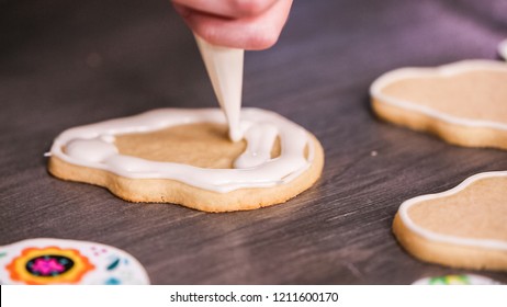 Step By Step. Flooding A Sugar Skull Cookie With White Royal Icing.