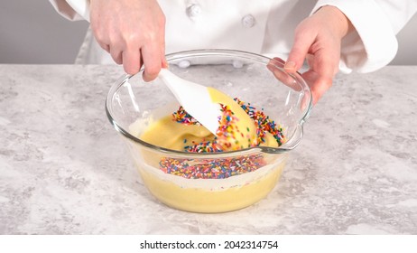 Step by step. Folding into the cake batter rainbow sprinkles to bake funfettti bundt cake.