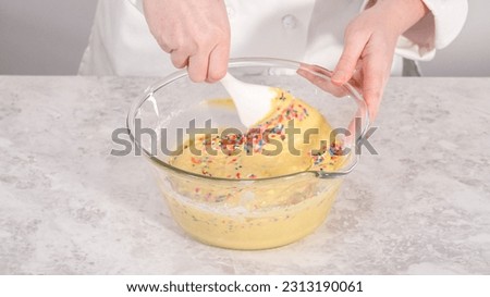 Step by step. Folding into the cake batter rainbow sprinkles to bake funfettti bundt cake.