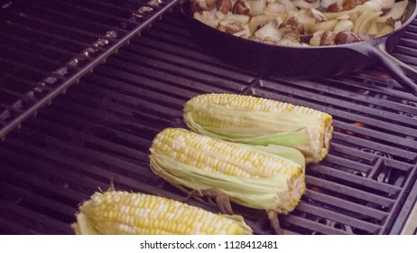 Step by step. Grilling fresh corn on outdoor gas grill. - Shutterstock ID 1128412481