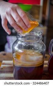 Step By Step How To Make Kombucha Tea, Adding A Glass Of The Previous Brew To The New Brew To Speed Up The Fermentation Process