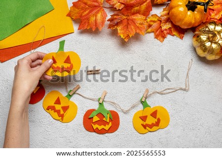 Step by step instruction: how to make a paper pumpkin  garland from colored cardboard or felt. Felt pumpkin for Halloween. Step 12