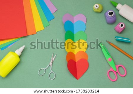 Step by step instructions. Hands with a rainbow heart. Step 2 Cut six hearts. LGBT