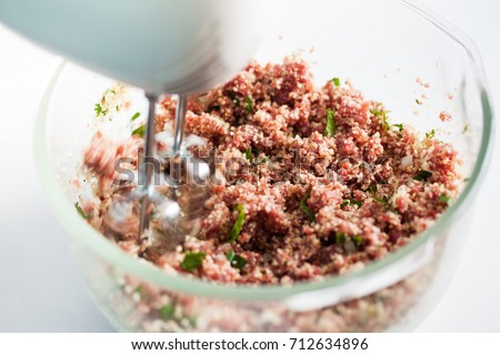 Step by step Levantine cuisine kibbeh preparation : Mixing the ingredients to prepare kibbeh into a bowl [[stock_photo]] © 