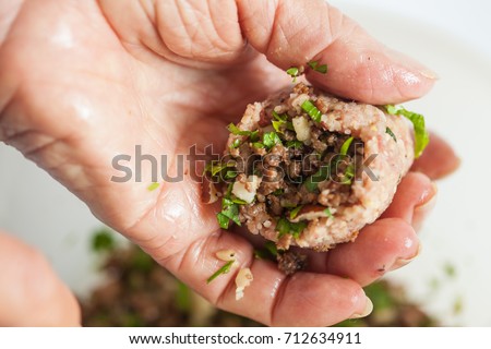 Step by step Levantine cuisine kibbeh preparation : Close up of a senior woman hands filling a kibbeh [[stock_photo]] © 