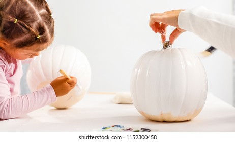 Step By Step. Mother And Daughter Decorating Halloween Craft Pumpkin With Unicorn Theme.