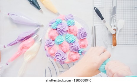 Step by step. Pastry chef piping butter cream frosting on unicorn cake for little girl birthday party. - Powered by Shutterstock